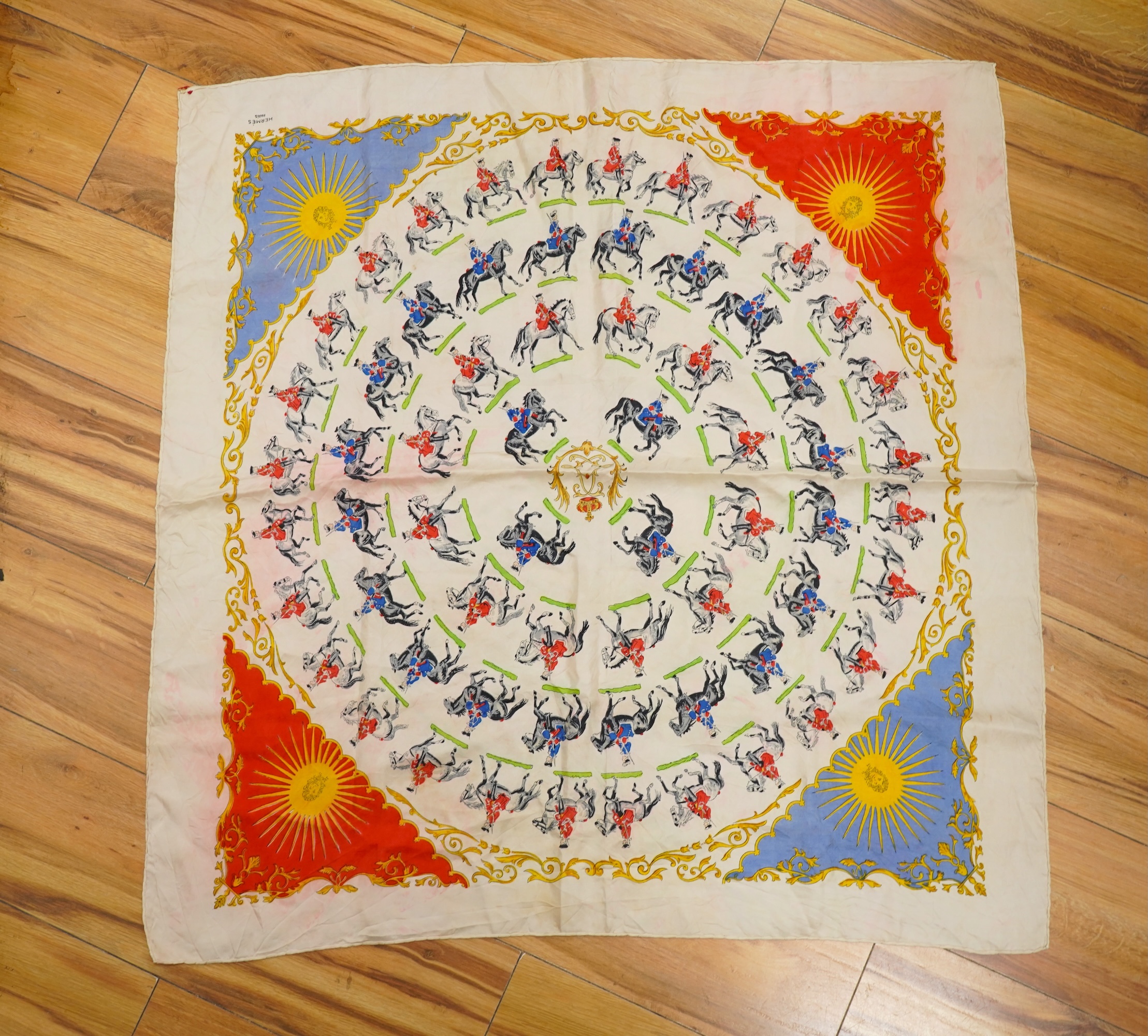A collection of three Hermes silk scarves and a Chanel monogram example